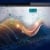 Large monitor showing a WatchGuard Cloud ThreatSync dashboard with waves of golden lights in front
