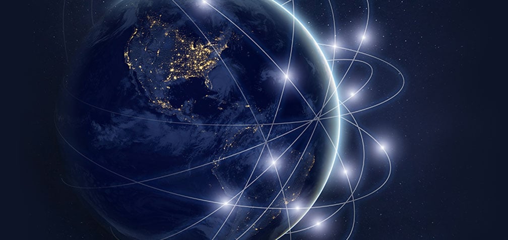 Earth with lights on in the northern hemisphere, the globe is surrounded by glowing white lines and dots
